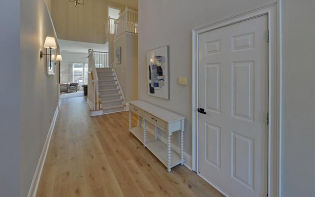 hallway with light hardwood / wood-style flooring