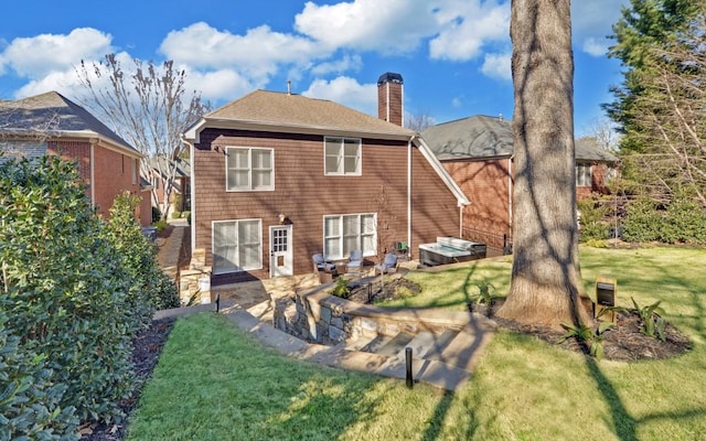 rear view of house with a yard and a patio