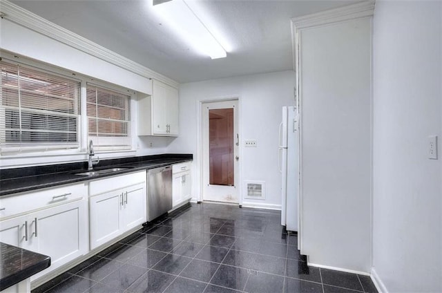 707 E Spring St E, Monroe, GA 30655 - kitchen featuring dishwasher, a sink, baseboards, and freestanding refrigerator