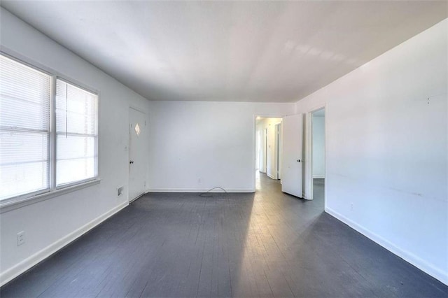 707 E Spring St E, Monroe, GA 30655 - empty room featuring dark wood finished floors and baseboards