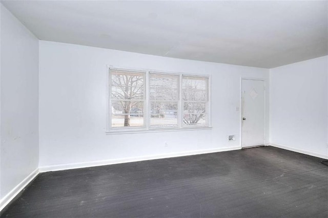 707 E Spring St E, Monroe, GA 30655 - spare room featuring dark wood finished floors and baseboards