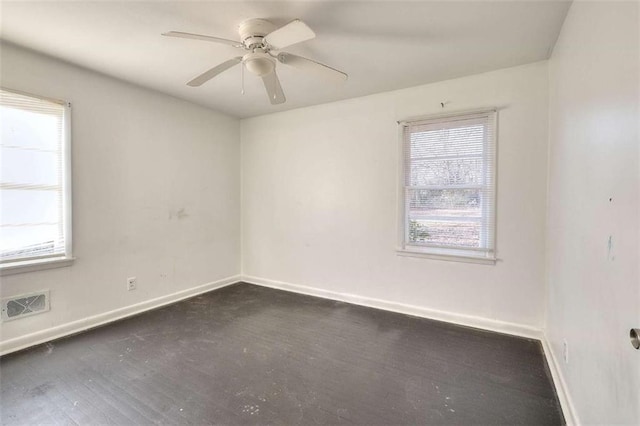 707 E Spring St E, Monroe, GA 30655 - empty room featuring healthy amount of natural light, baseboards, and a ceiling fan