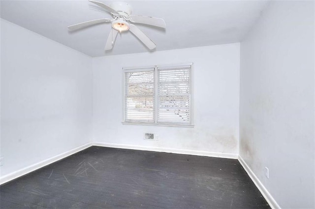 707 E Spring St E, Monroe, GA 30655 - spare room with baseboards, dark wood-type flooring, and a ceiling fan