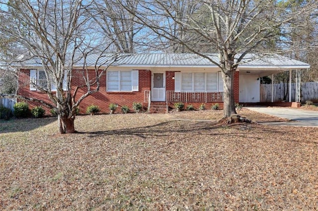 707 E Spring St E, Monroe, GA 30655 - ranch-style house featuring brick siding, fence, a carport, and concrete driveway
