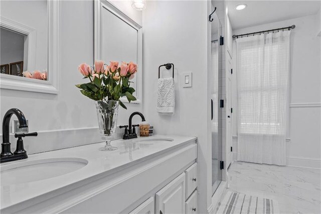 137 Oakton S, Eatonton, GA 31024 - full bath with marble finish floor, a sink, double vanity, and a stall shower