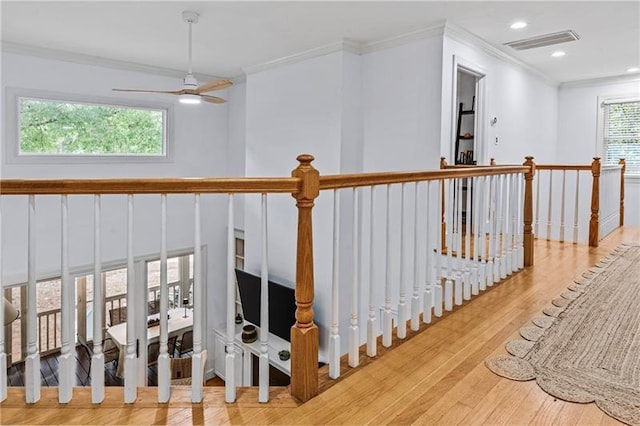 137 Oakton S, Eatonton, GA 31024 - hall featuring wood finished floors, an upstairs landing, ornamental molding, visible vents, and recessed lighting