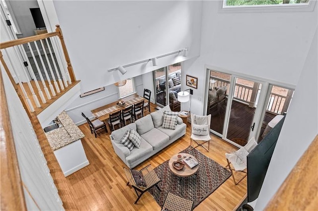 137 Oakton S, Eatonton, GA 31024 - living room with stairway, a high ceiling, and wood finished floors