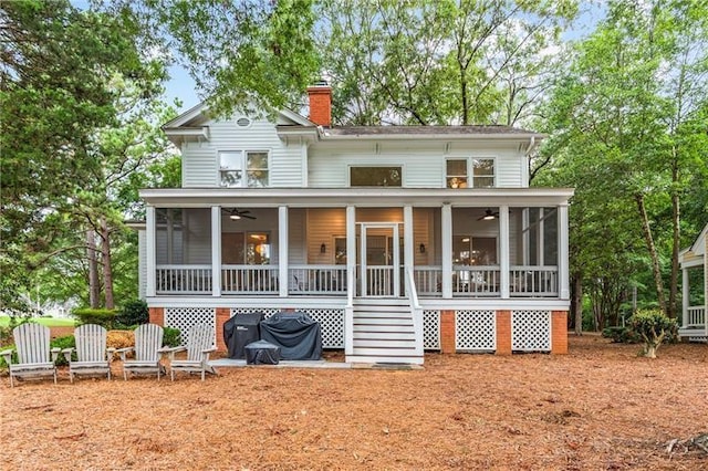 137 Oakton S, Eatonton, GA 31024 - rear view of house with a chimney, a sunroom, stairs, and ceiling fan
