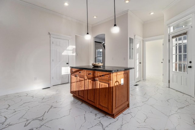 kitchen featuring brown cabinetry, recessed lighting, ornamental molding, decorative light fixtures, and marble finish floor