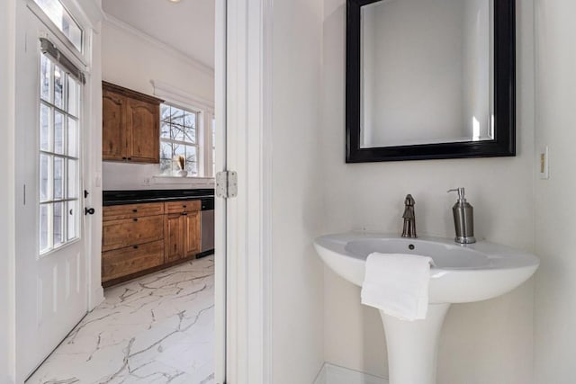 bathroom with marble finish floor and ornamental molding