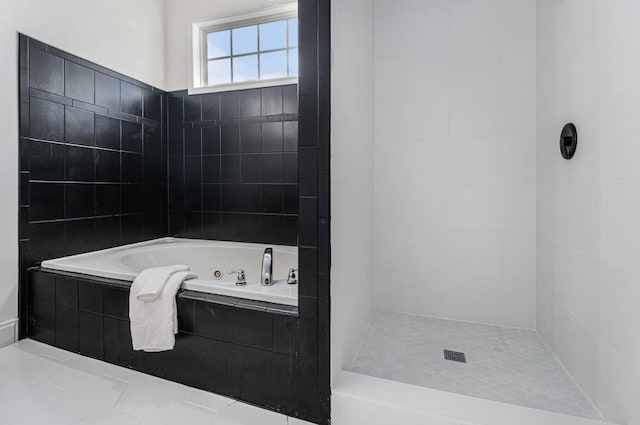 full bathroom featuring a jetted tub and a tile shower