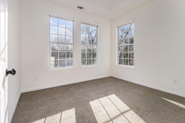 spare room with baseboards, visible vents, carpet floors, and a healthy amount of sunlight