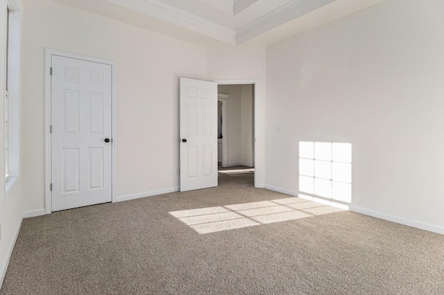 unfurnished bedroom with baseboards, carpet, and crown molding