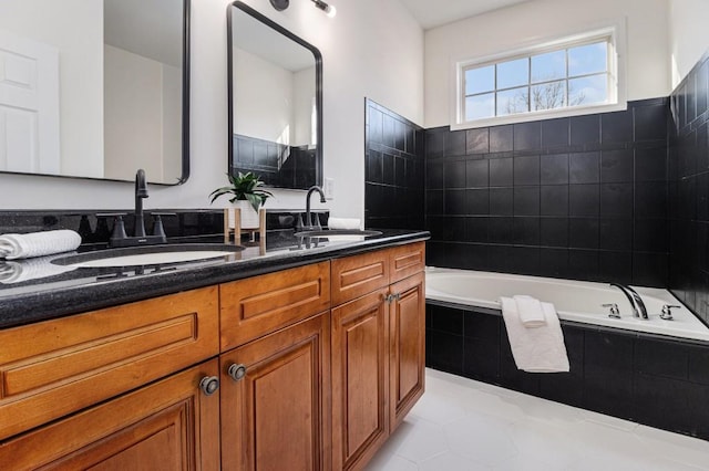 bathroom featuring a sink, a garden tub, and double vanity