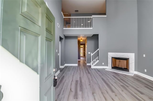6269 Colonial Vw, Fairburn, GA 30213 - entrance foyer with wood finished floors, baseboards, a towering ceiling, and a high end fireplace