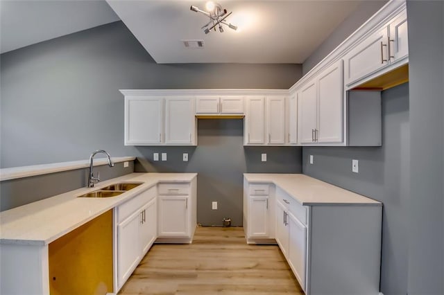 6269 Colonial Vw, Fairburn, GA 30213 - kitchen with a sink, light wood-style flooring, white cabinets, a peninsula, and light countertops