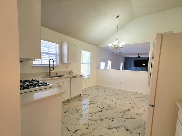 kitchen featuring pendant lighting, lofted ceiling, white appliances, white cabinets, and sink