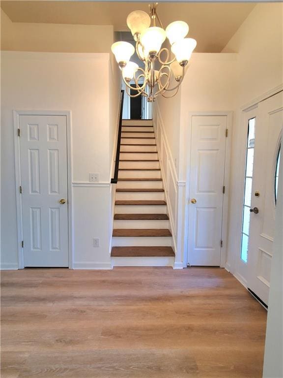 entryway featuring a chandelier and light hardwood / wood-style flooring