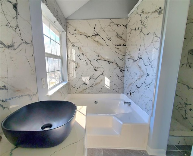 bathroom with plus walk in shower, tile patterned floors, and tile walls