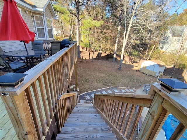 wooden deck featuring a storage shed