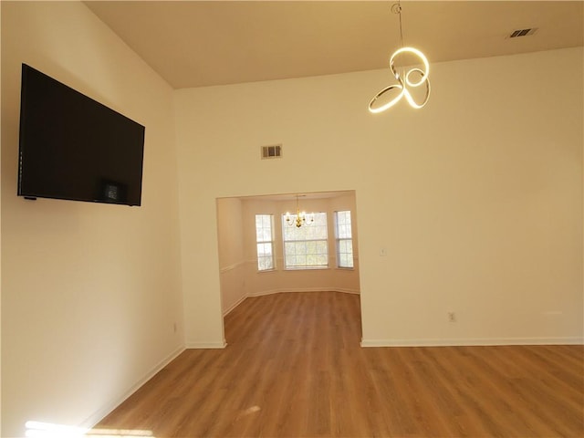 interior space featuring hardwood / wood-style floors and a notable chandelier