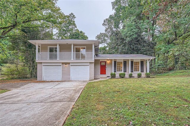 split level home with a porch, a garage, and a front yard