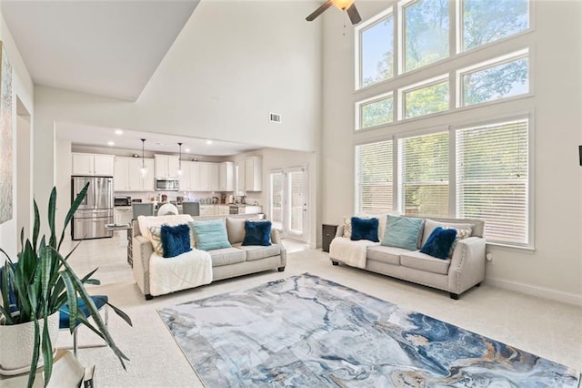297 Aylesbury Blvd, Mcdonough, GA 30252 - living room featuring light carpet, a high ceiling, and a ceiling fan