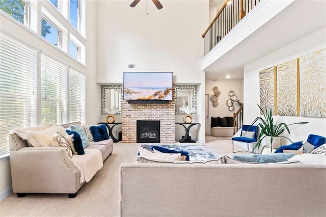 297 Aylesbury Blvd, Mcdonough, GA 30252 - carpeted living room featuring a high ceiling, a ceiling fan, and a brick fireplace