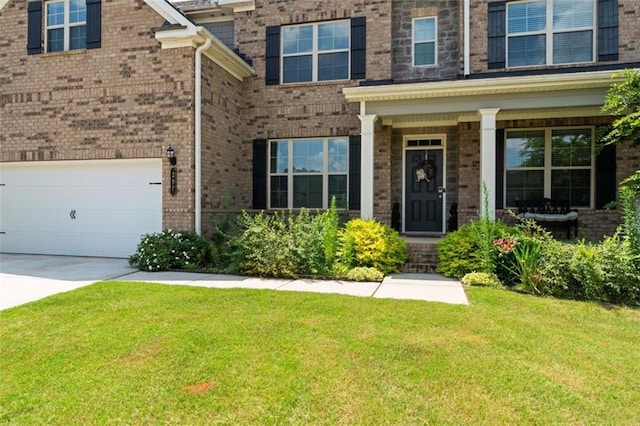 297 Aylesbury Blvd, Mcdonough, GA 30252 - entrance to property with a yard, brick siding, concrete driveway, and an attached garage