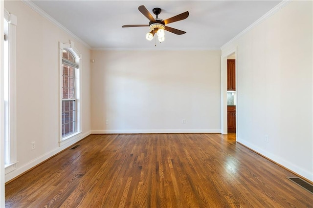 spare room with crown molding, ceiling fan, and dark hardwood / wood-style floors