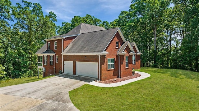 view of front facade with an attached garage, concrete driveway, a front yard, and brick siding
