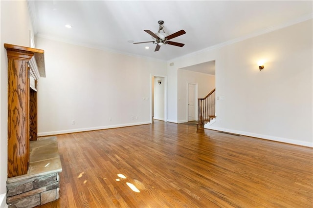 unfurnished living room featuring crown molding, a ceiling fan, and wood finished floors