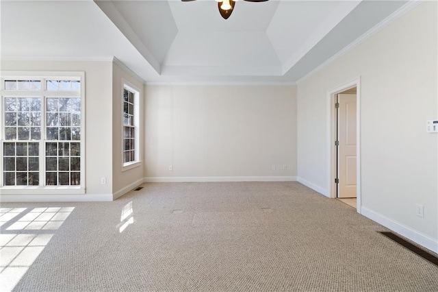 spare room with light carpet, ceiling fan, and baseboards