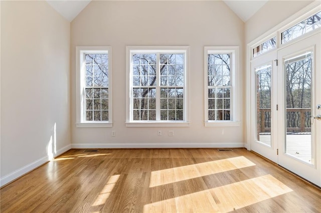 unfurnished sunroom with lofted ceiling