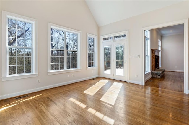 unfurnished sunroom featuring a fireplace and vaulted ceiling