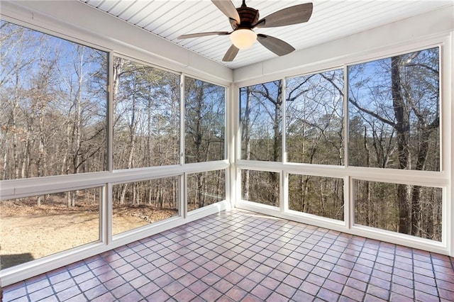 unfurnished sunroom with ceiling fan