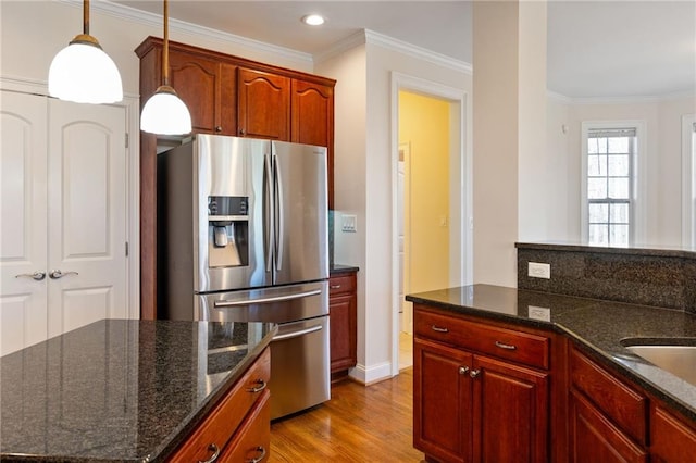 kitchen featuring stainless steel refrigerator with ice dispenser, decorative light fixtures, ornamental molding, recessed lighting, and wood finished floors