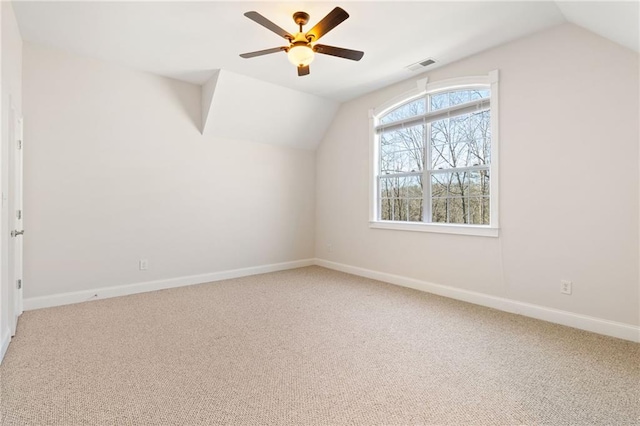 additional living space featuring vaulted ceiling, carpet flooring, and ceiling fan