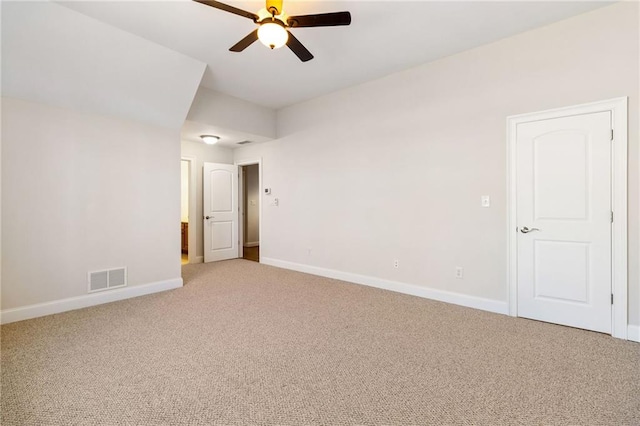 empty room featuring carpet, visible vents, baseboards, and a ceiling fan