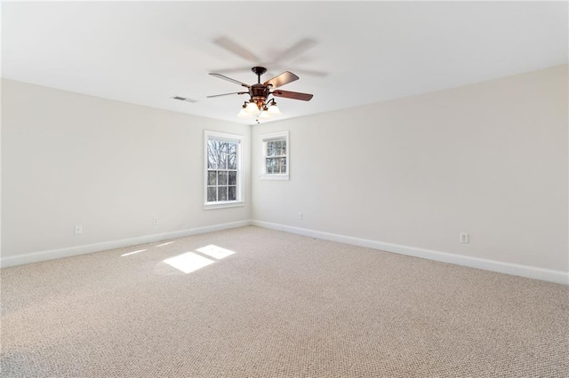 carpeted spare room featuring ceiling fan