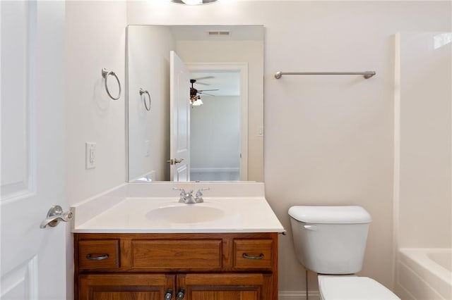 bathroom with visible vents, toilet, ceiling fan, a tub to relax in, and vanity