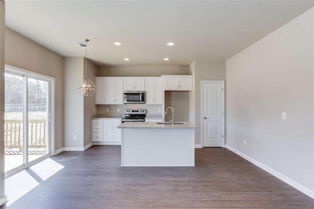 kitchen with dark wood-type flooring, white cabinets, stainless steel appliances, and sink