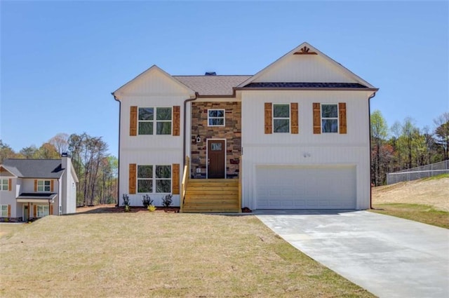 bi-level home featuring a garage and a front lawn