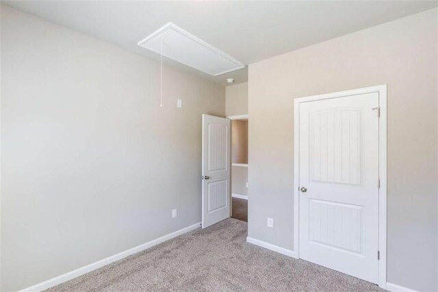 unfurnished bedroom featuring light carpet