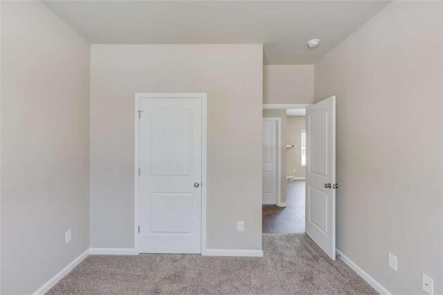 unfurnished bedroom with light carpet