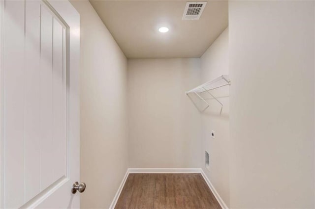 laundry room with electric dryer hookup and hardwood / wood-style floors