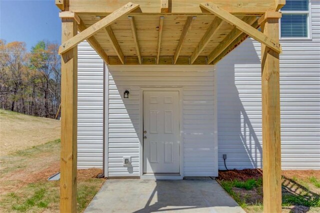 property entrance with a carport