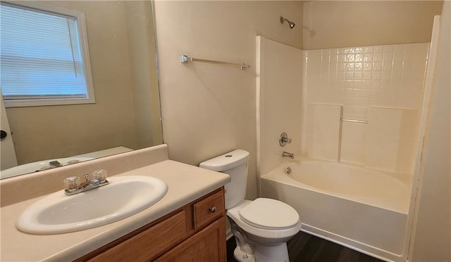 full bathroom featuring vanity, hardwood / wood-style floors, tub / shower combination, and toilet