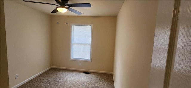 carpeted spare room with ceiling fan