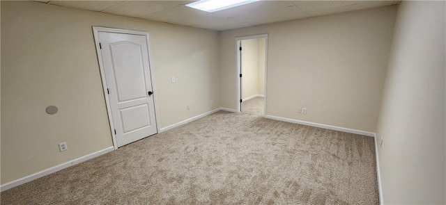 spare room featuring light carpet